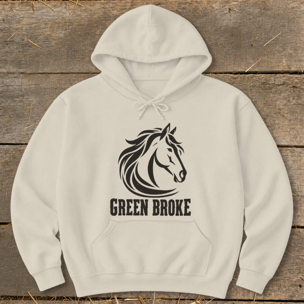 A cream-colored hoodie featuring a black graphic of a horse's head and the text "GREEN BROKE."