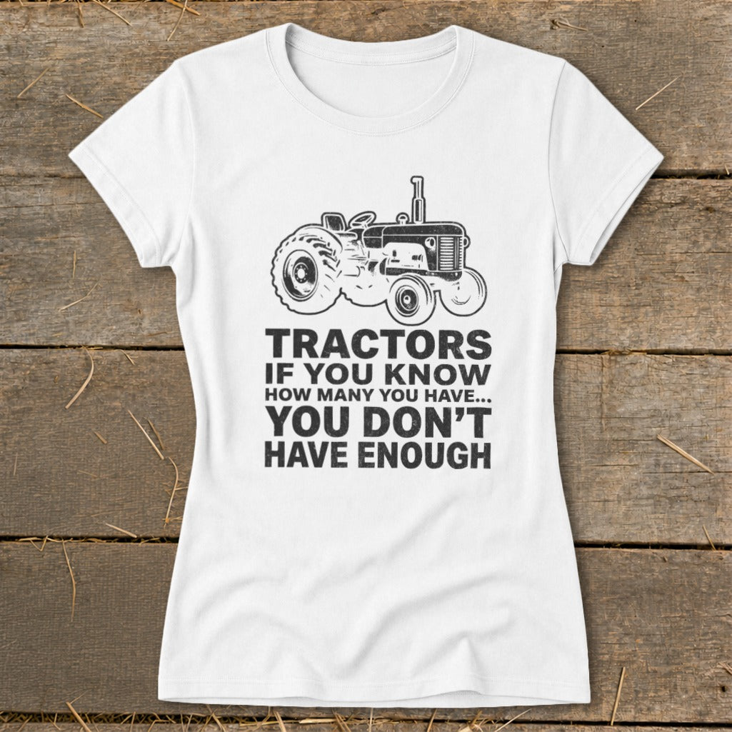 White t-shirt with a vintage tractor graphic and "Tractors if you know how many you have... you don't have enough" text.