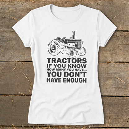 White t-shirt with a vintage tractor graphic and "Tractors if you know how many you have... you don't have enough" text.