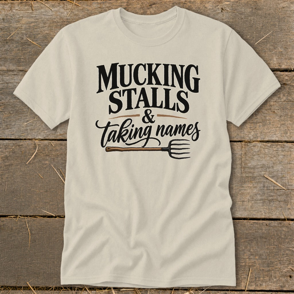 Cream t-shirt with "MUCKING STALLS & Taking names" and a pitchfork.