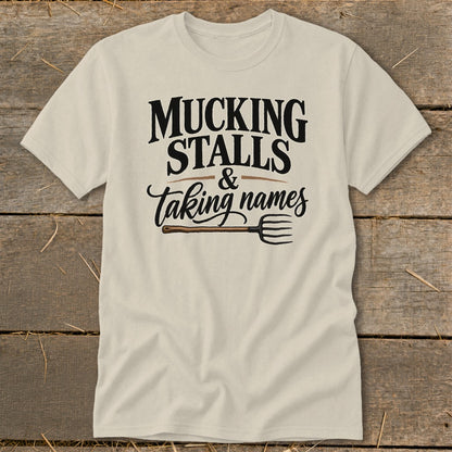 Cream t-shirt with "MUCKING STALLS & Taking names" and a pitchfork.