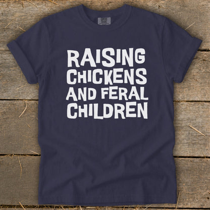 Navy t-shirt with white text reading "Raising Chickens and Feral Children"