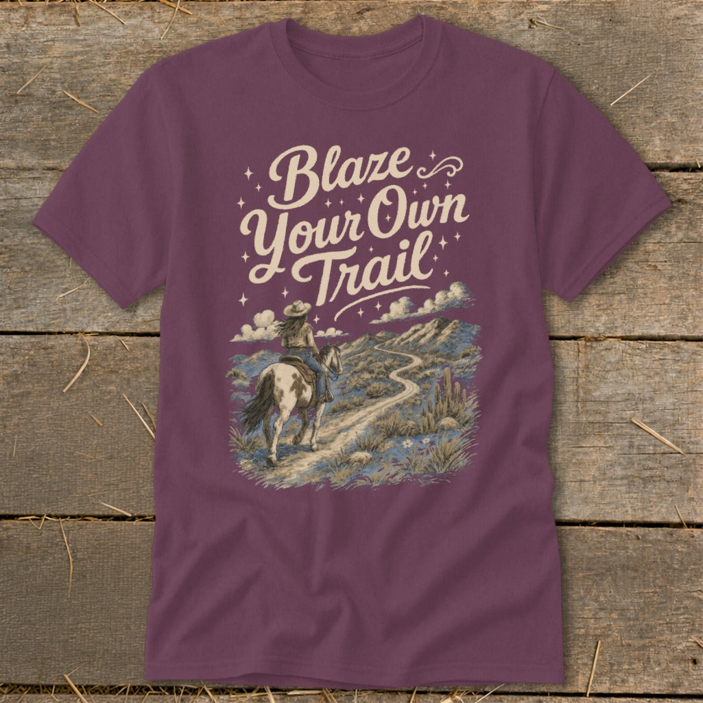 T-shirt with "Blaze Your Own Trail" text and a woman riding a horse on a desert path.