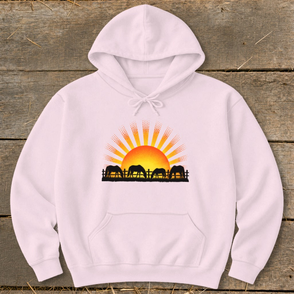 Hoodie with black silhouette of horses grazing at sunrise.