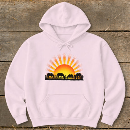 Hoodie with black silhouette of horses grazing at sunrise.