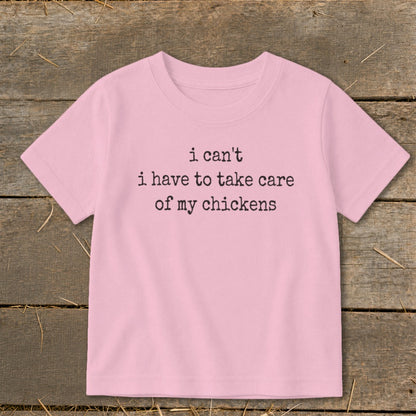 Pink t-shirt with black text that says "i can't i have to take care of my chickens".