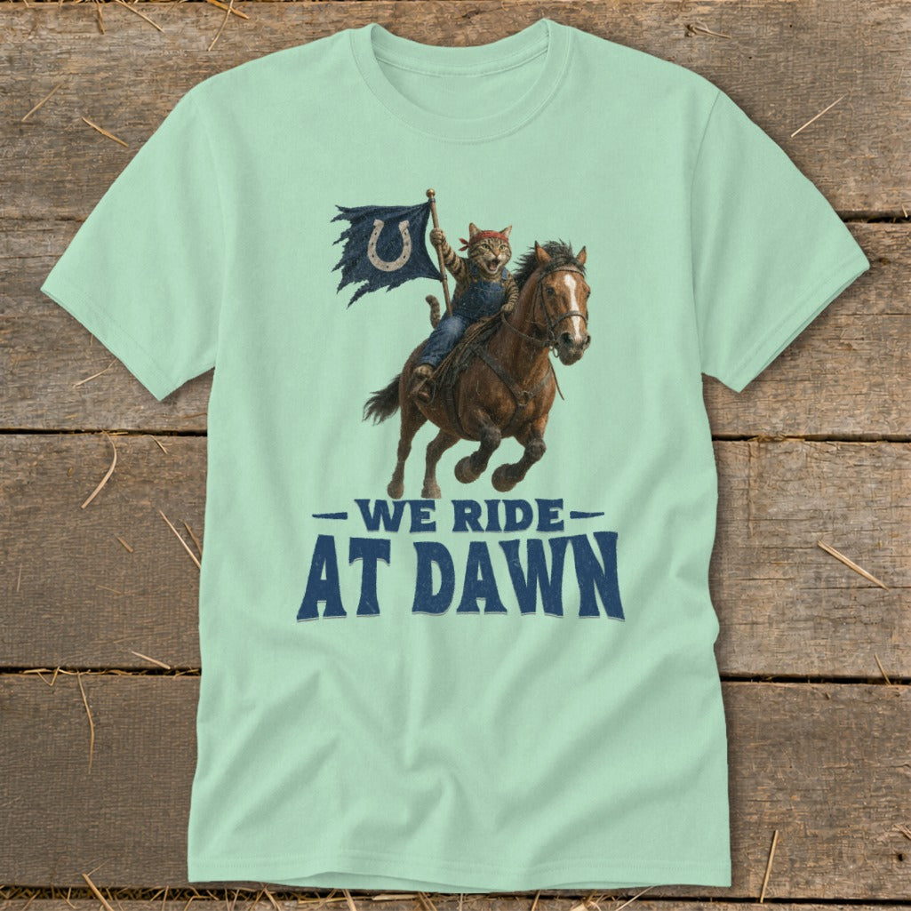 Cat riding a horse carrying a tattered flag with a horseshoe, text "WE RIDE AT DAWN."