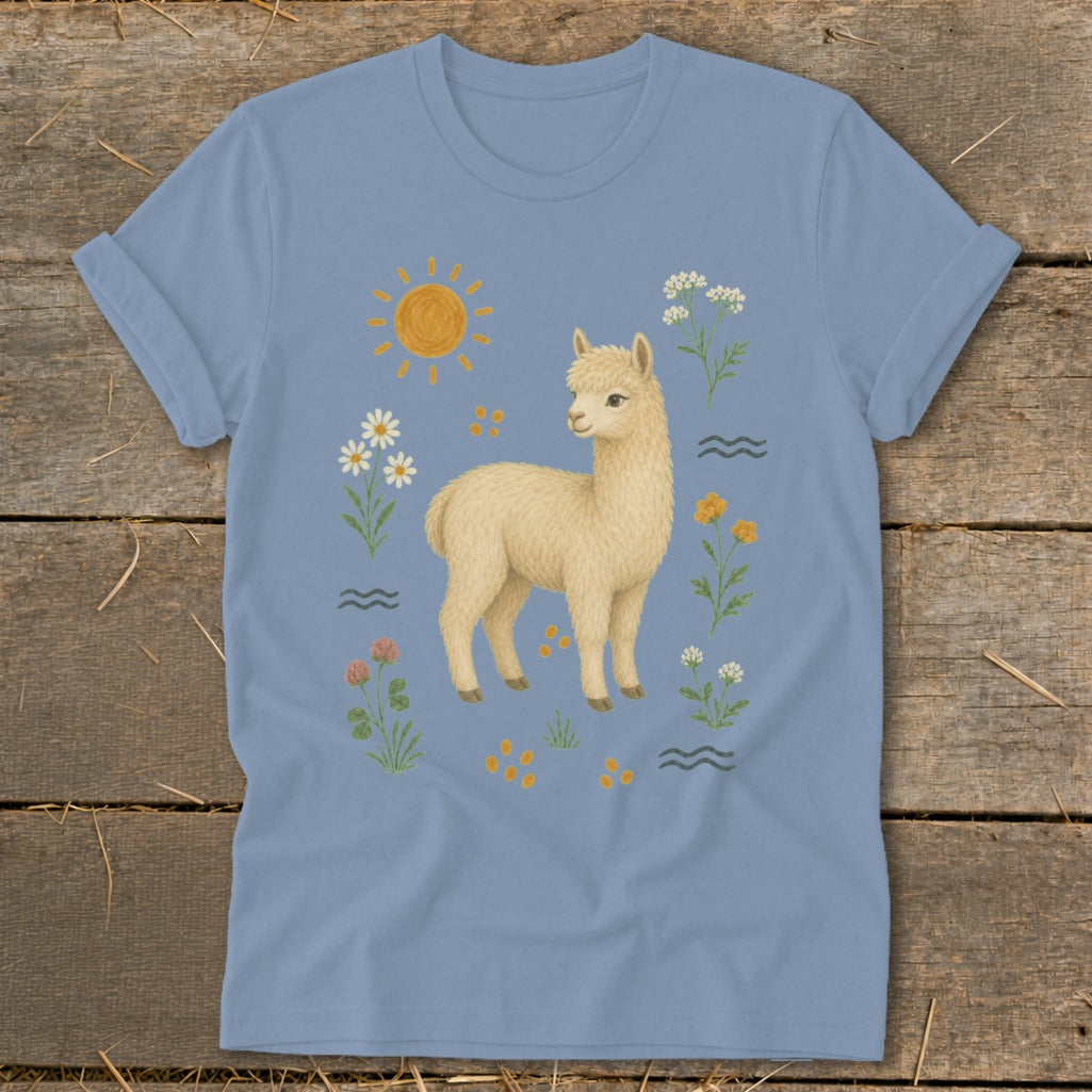Light blue t-shirt with a cream-colored alpaca, sun, and floral design.