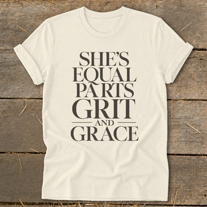 Cream t-shirt with "She's Equal Parts Grit and Grace" text design.