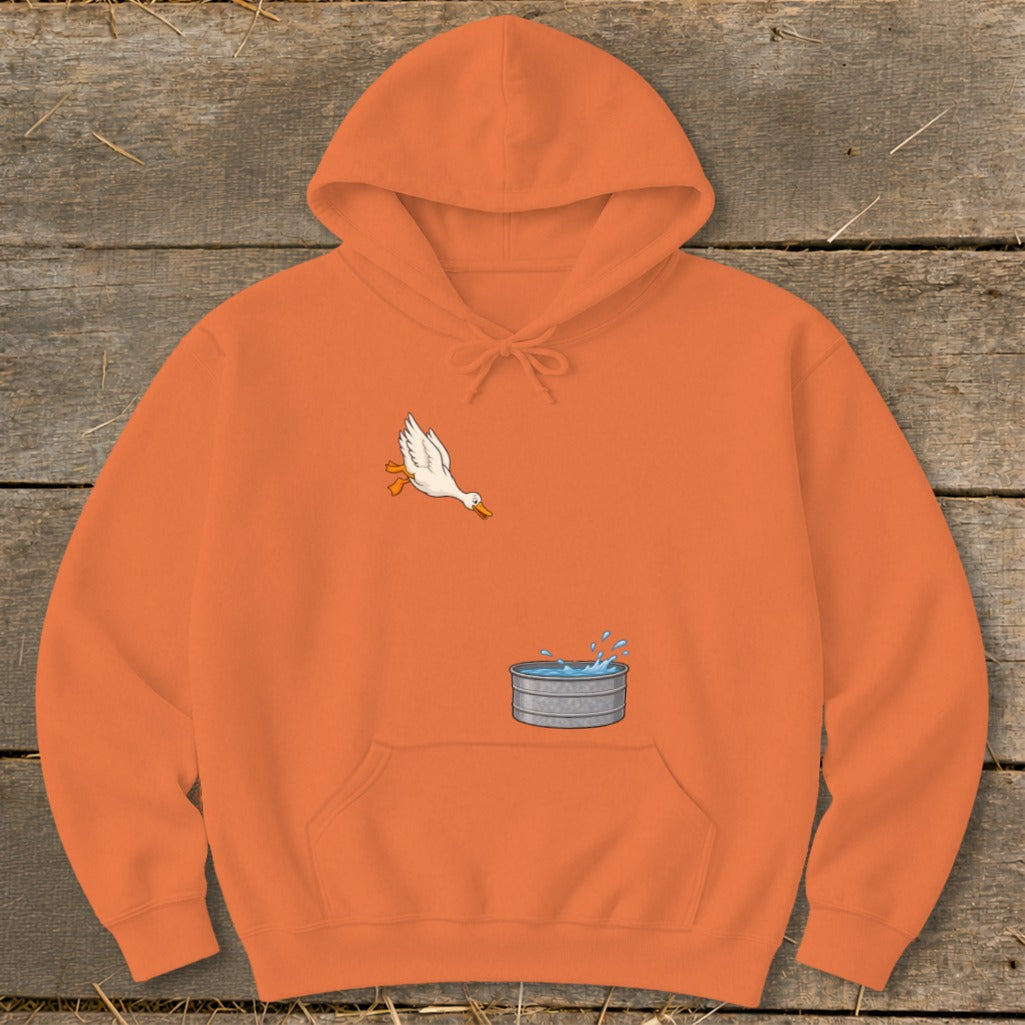 Orange hoodie with a white duck jumping into a metal tub of water.
