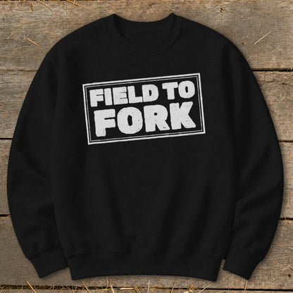 Black crewneck sweatshirt featuring a distressed white graphic that reads FIELD TO FORK inside a rectangular box.
