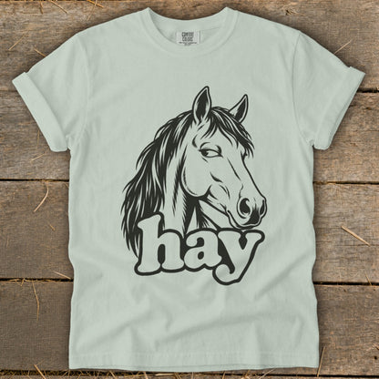 Light green t-shirt with black horse head graphic and "hay" text.