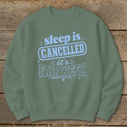 Olive green sweatshirt with "sleep is CANCELLED it's FAIR WEEK" text design.