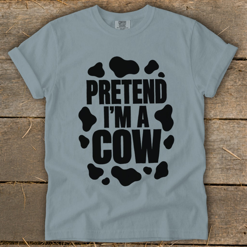 Light blue t-shirt with black text "PRETEND I'M A COW" and cow spots.