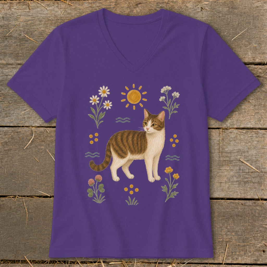 Purple t-shirt with a tabby cat illustration surrounded by flowers and a sun.
