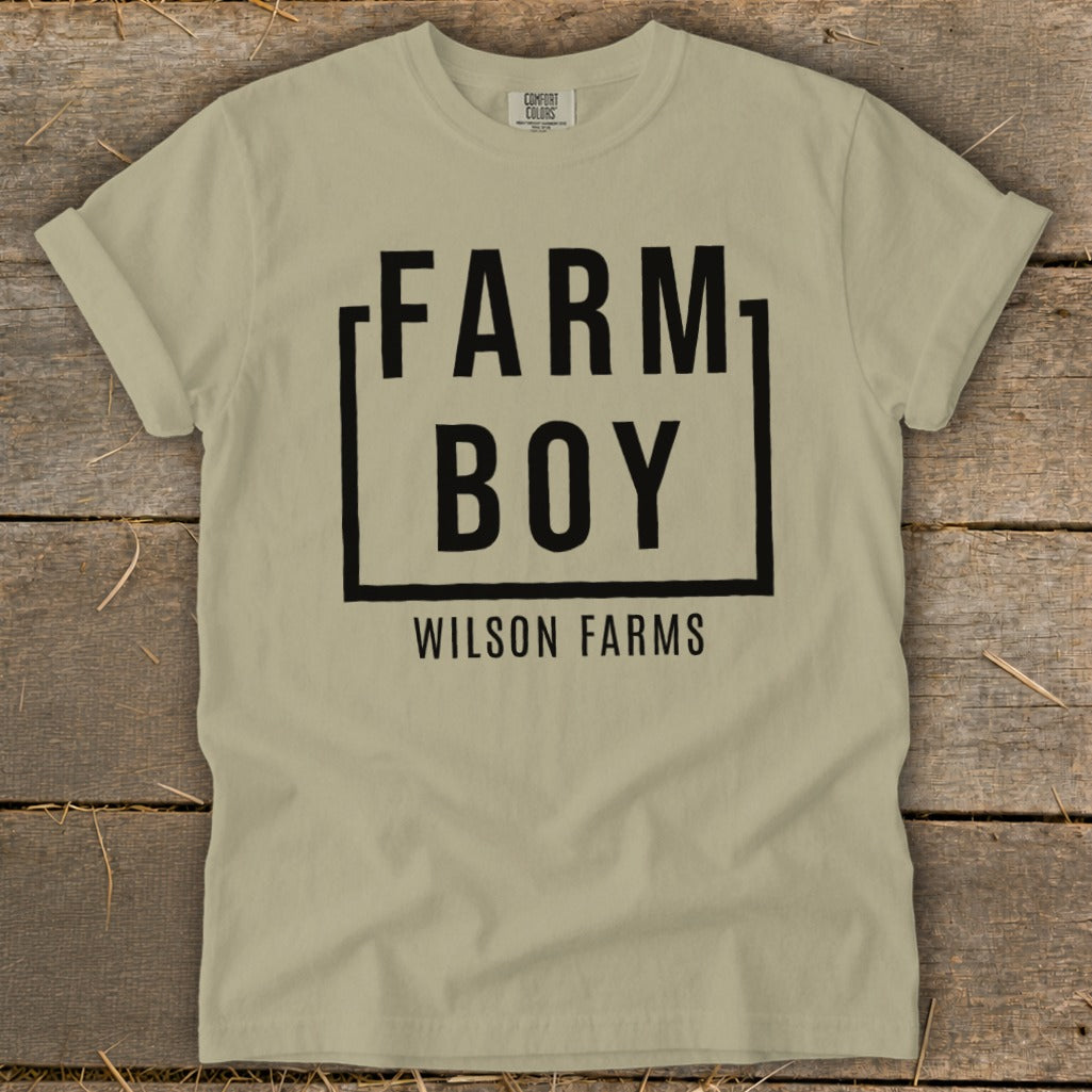 Tan t-shirt with black text "FARM BOY WILSON FARMS" in a box.