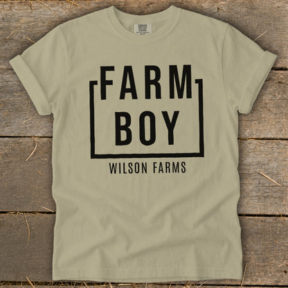 Tan t-shirt with black text "FARM BOY WILSON FARMS" in a box.
