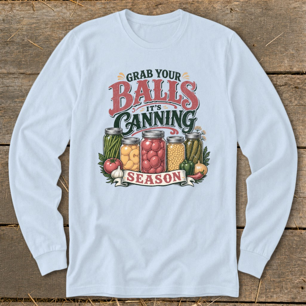 Light blue long sleeve shirt with "Grab Your Balls It's Canning Season" graphic and canned vegetables.