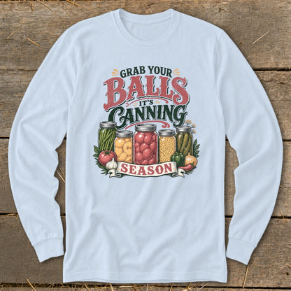 Light blue long sleeve shirt with "Grab Your Balls It's Canning Season" graphic and canned vegetables.