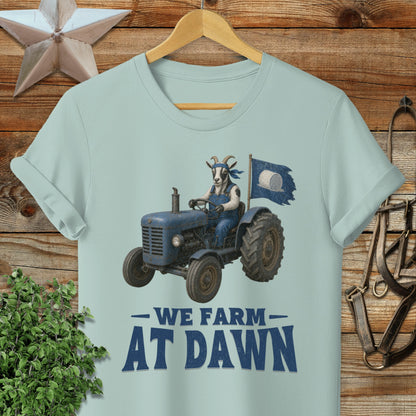 Blue tractor with goat driver, flag, and text "We Farm At Dawn".