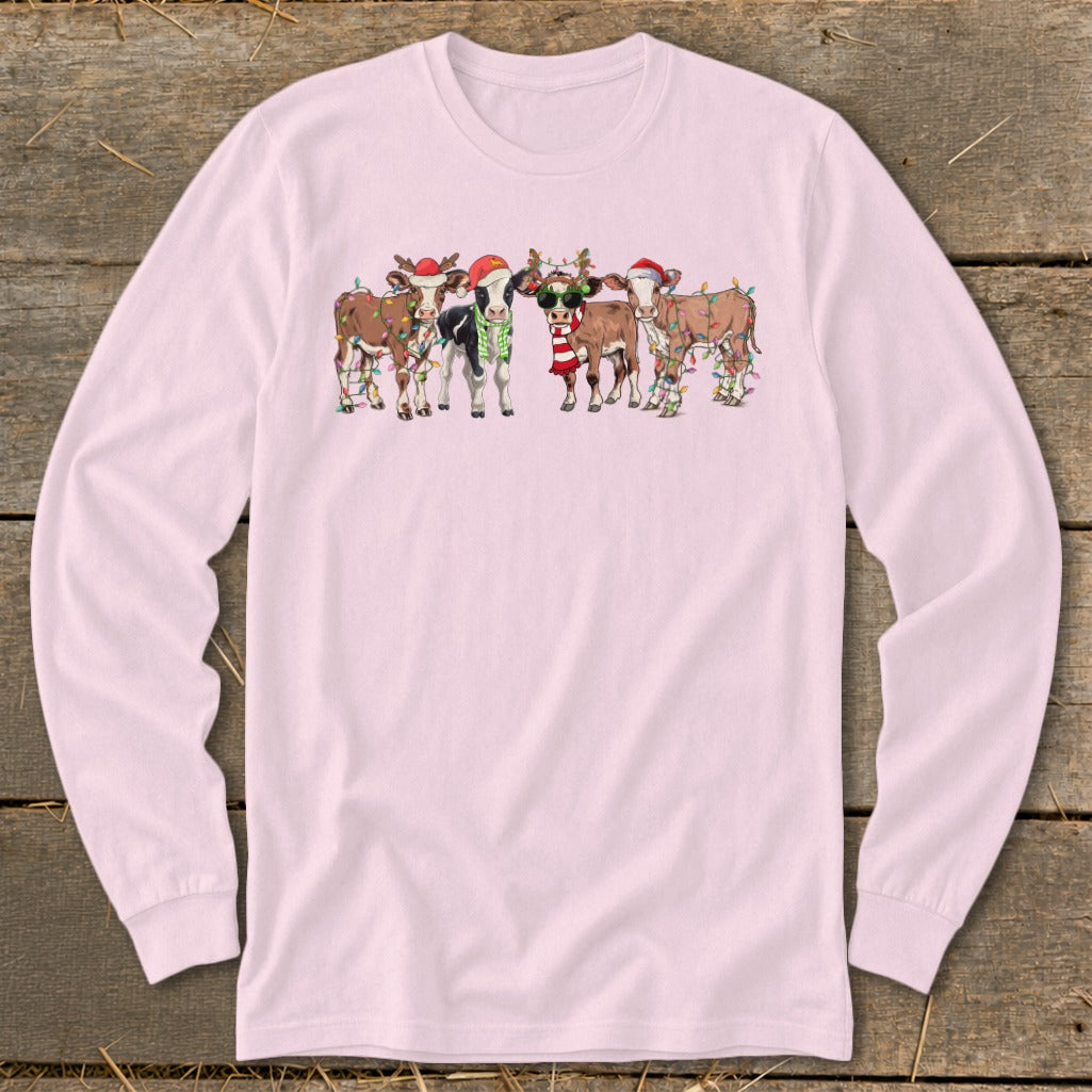 Five festive cows wearing Santa hats and Christmas lights.