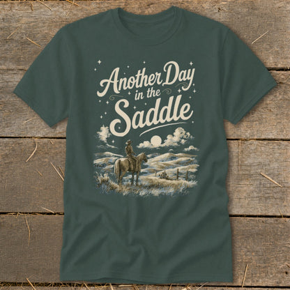 Green t-shirt with "Another Day in the Saddle" text and cowboy on horseback graphic.