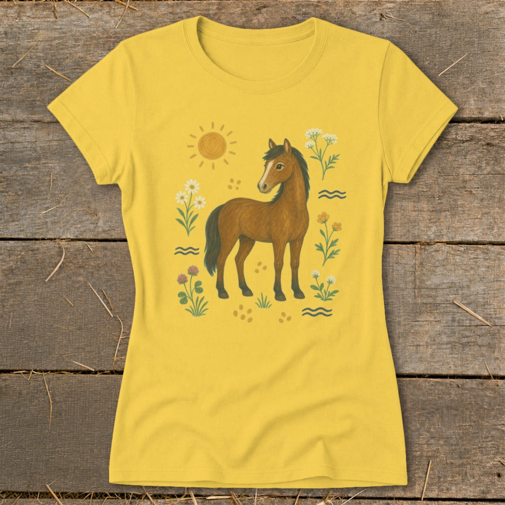 Yellow t-shirt with a brown horse, sun, and wildflowers illustration.