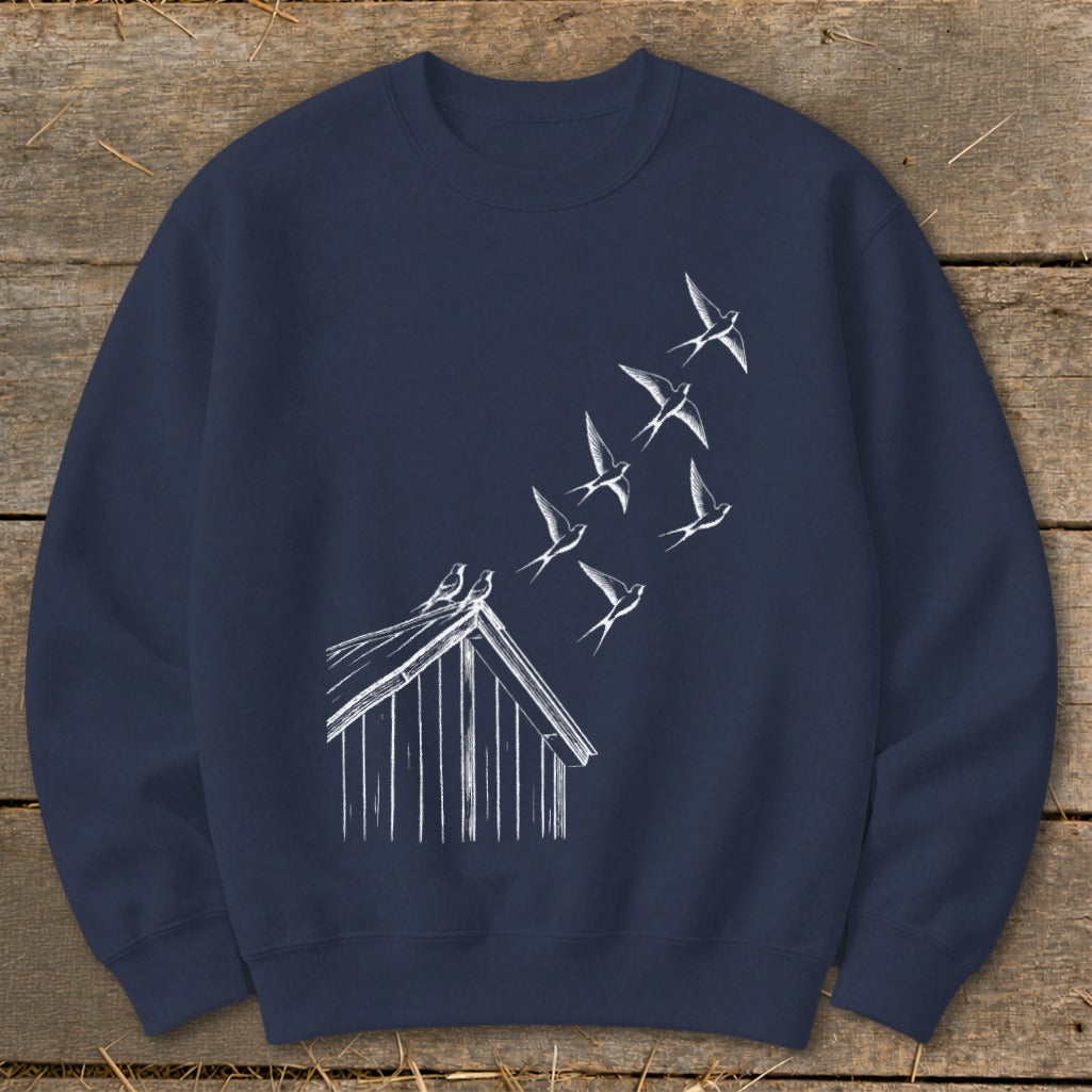 Dark blue crewneck sweatshirt featuring a white sketch of birds flying upward from a shed roof.