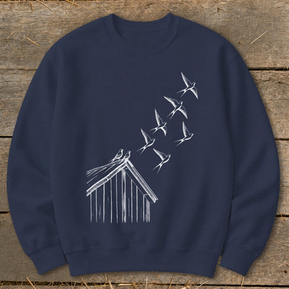 Dark blue crewneck sweatshirt featuring a white sketch of birds flying upward from a shed roof.