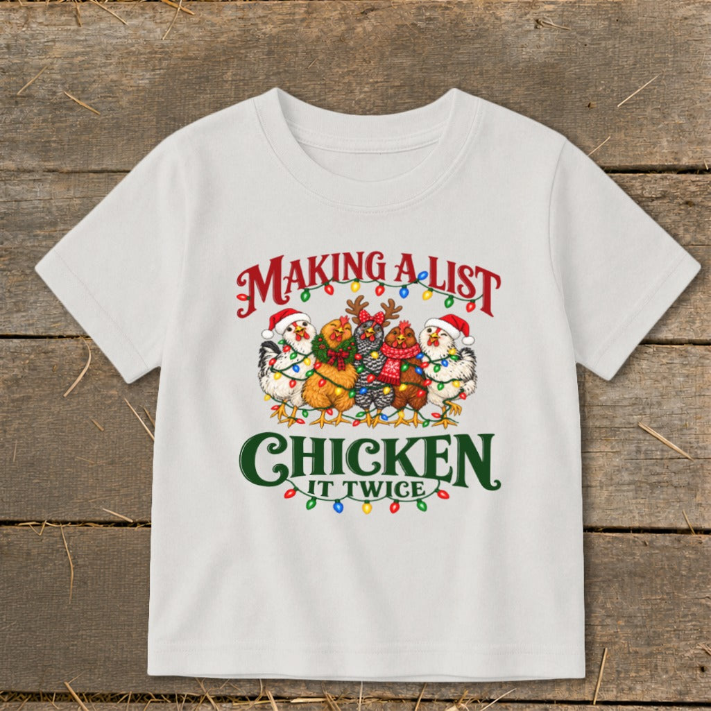White t-shirt with "Making A List Chicken It Twice" text and festive chickens.