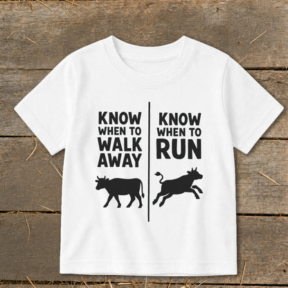 White t-shirt with black text and cow graphics: "Know When To Walk Away" and "Know When To Run".