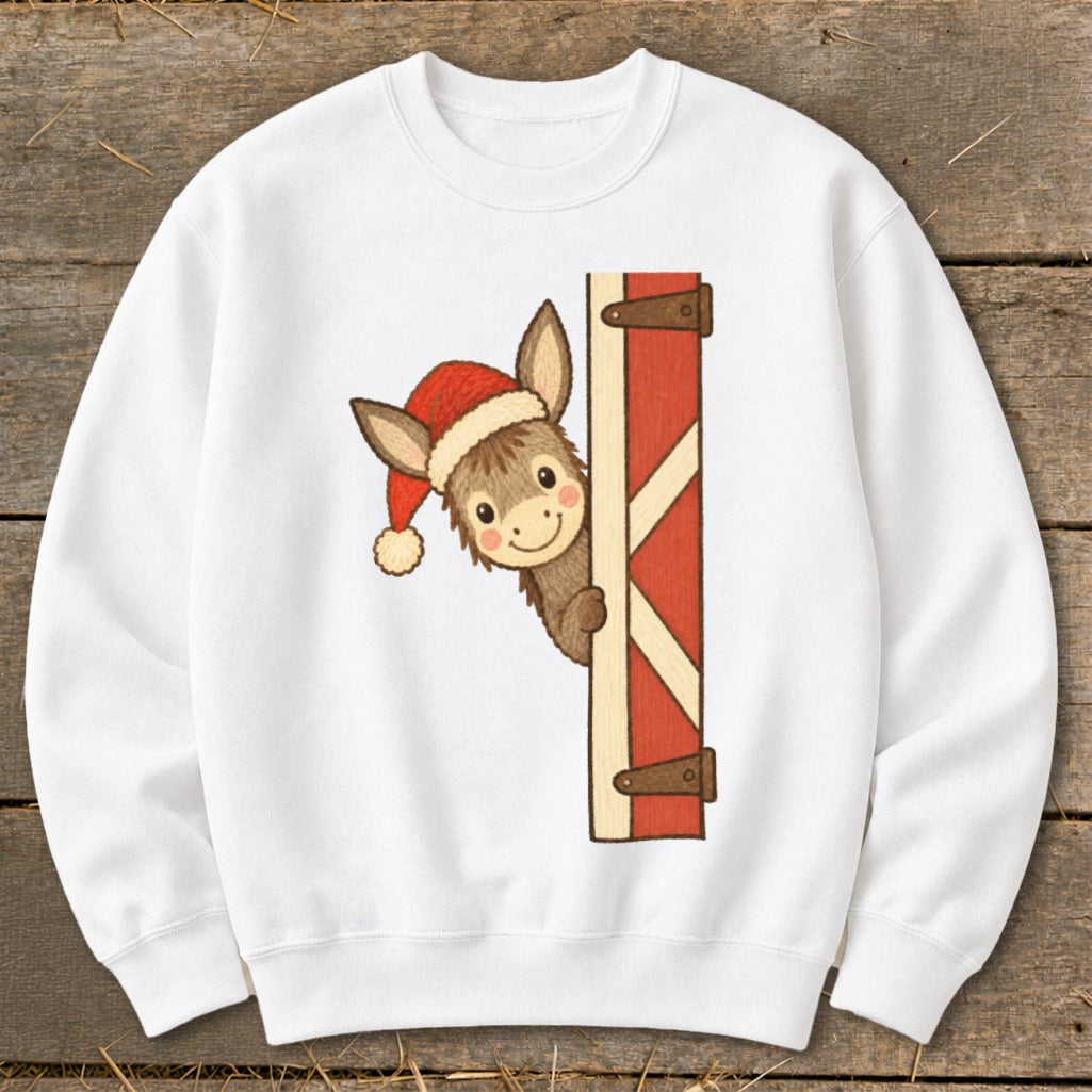 White sweatshirt with a cartoon donkey wearing a Santa hat peeking from behind a barn door.