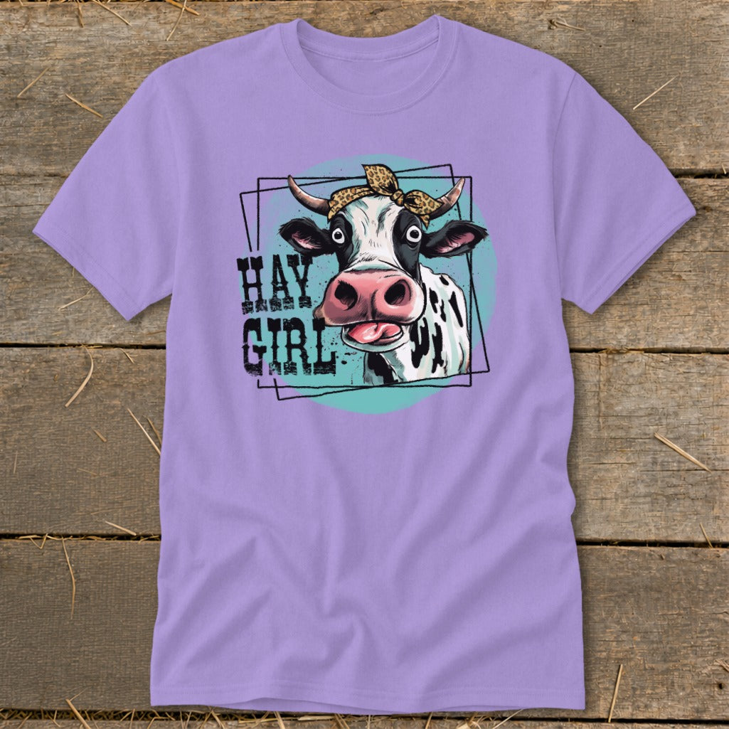 Lavender t-shirt with a graphic of a cow wearing a leopard print bandana, text "HAY GIRL".