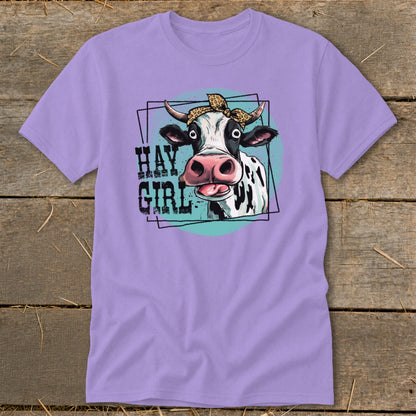 Lavender t-shirt with a graphic of a cow wearing a leopard print bandana, text "HAY GIRL".