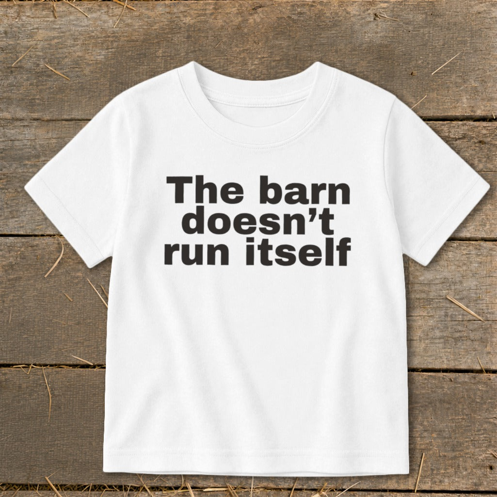 White t-shirt with black text reading "The barn doesn't run itself".