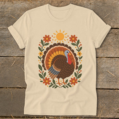 Cream t-shirt with a graphic of a turkey surrounded by flowers and a sun.