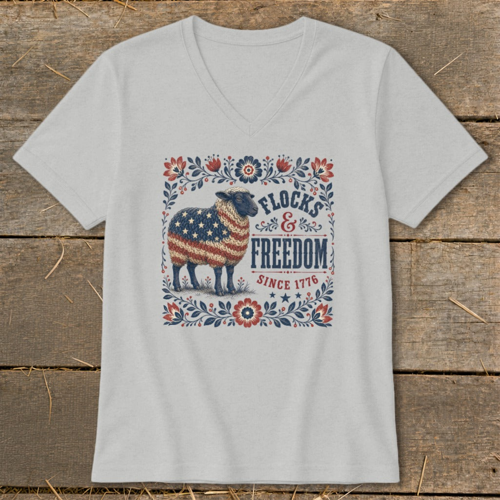 Sheep with US flag pattern on its wool, surrounded by floral border, with text "FLOCKS & FREEDOM SINCE 1776".