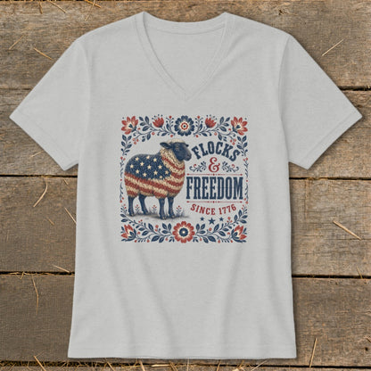 Sheep with US flag pattern on its wool, surrounded by floral border, with text "FLOCKS & FREEDOM SINCE 1776".