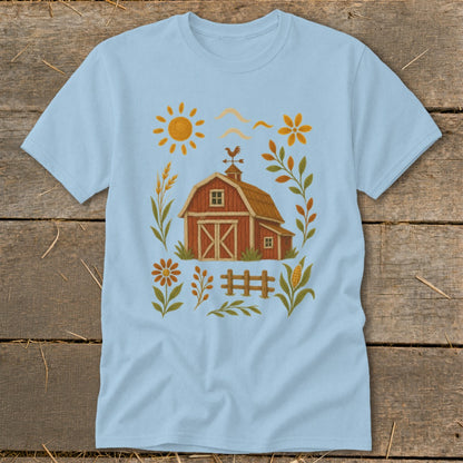 Light blue t-shirt with a rustic farm graphic featuring a barn, sun, and floral elements.