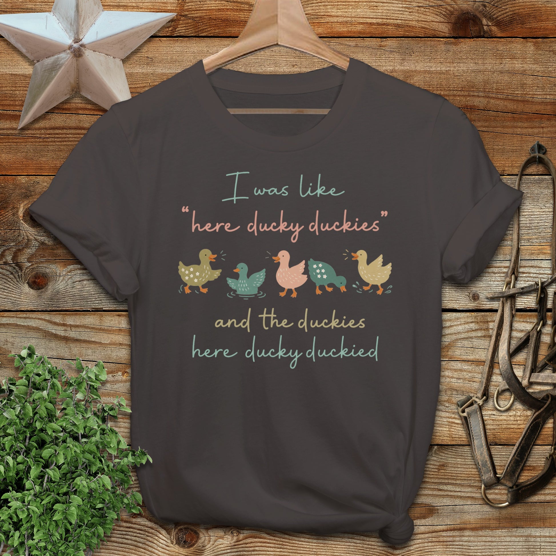 Dark t-shirt with "I was like 'here ducky duckies' and the duckies here ducky duckied" text and cartoon ducks.