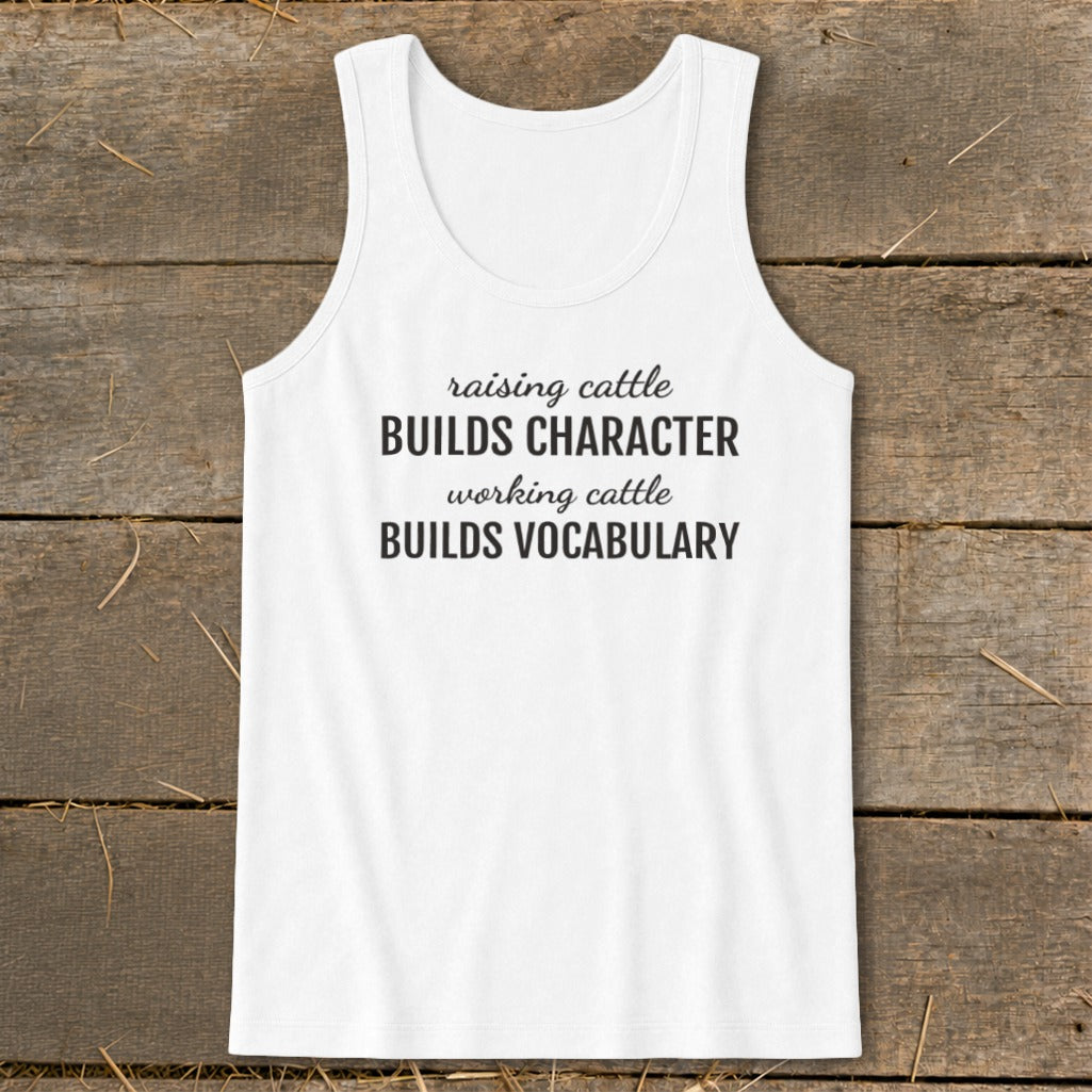 White tank top with black text: "raising cattle BUILDS CHARACTER, working cattle BUILDS VOCABULARY."