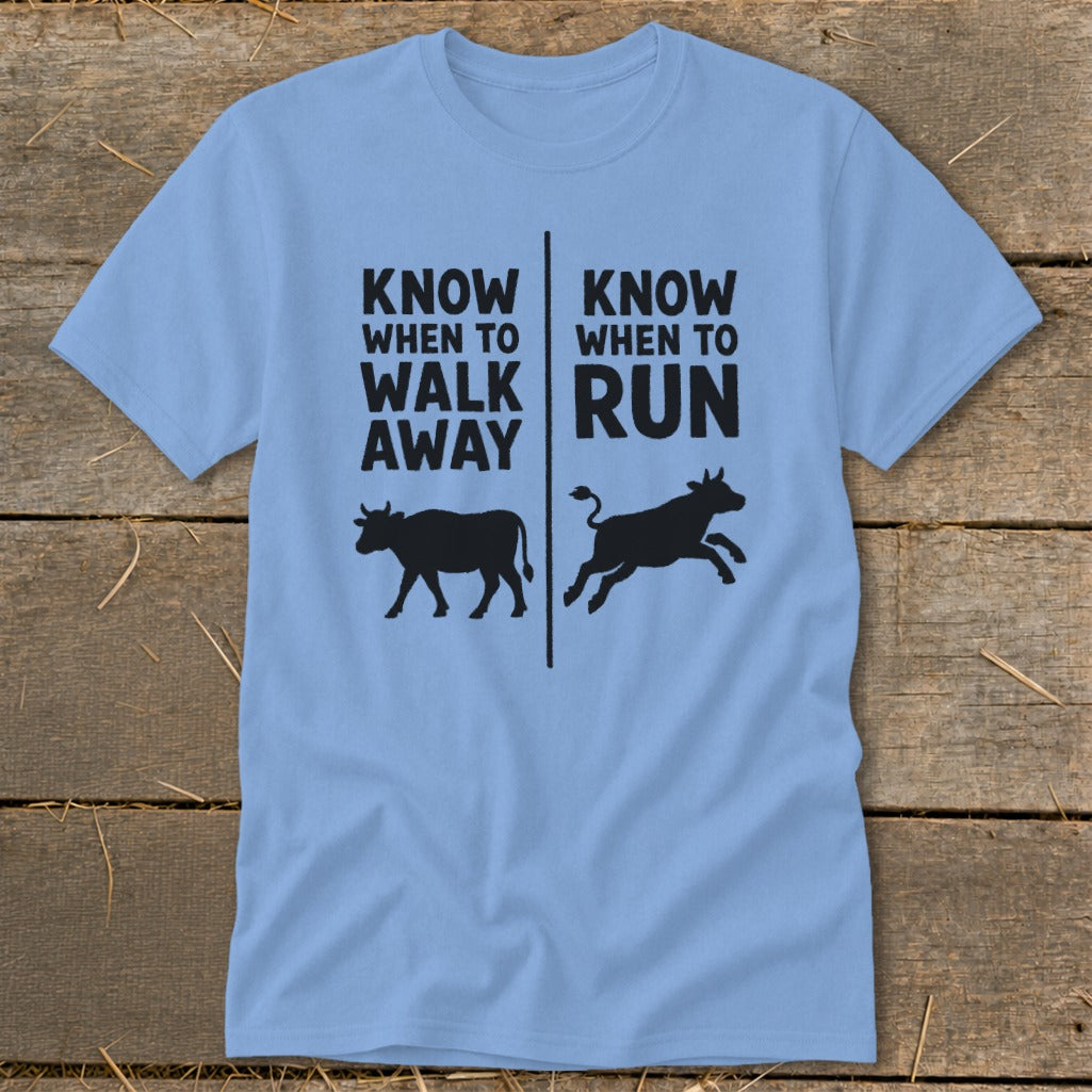 Light blue t-shirt with black text and cow silhouettes: "Know when to walk away" and "Know when to run".