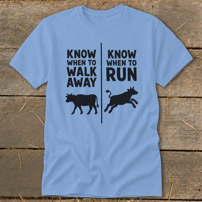 Light blue t-shirt with black text and cow silhouettes: "Know when to walk away" and "Know when to run".