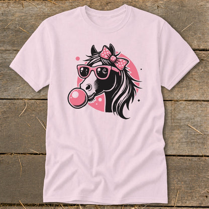 Pink t-shirt with graphic of a horse wearing sunglasses and a bow, blowing bubblegum.