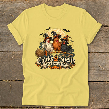 Three witch-hatted chickens sit on a broom with text "Chicks & Spells"