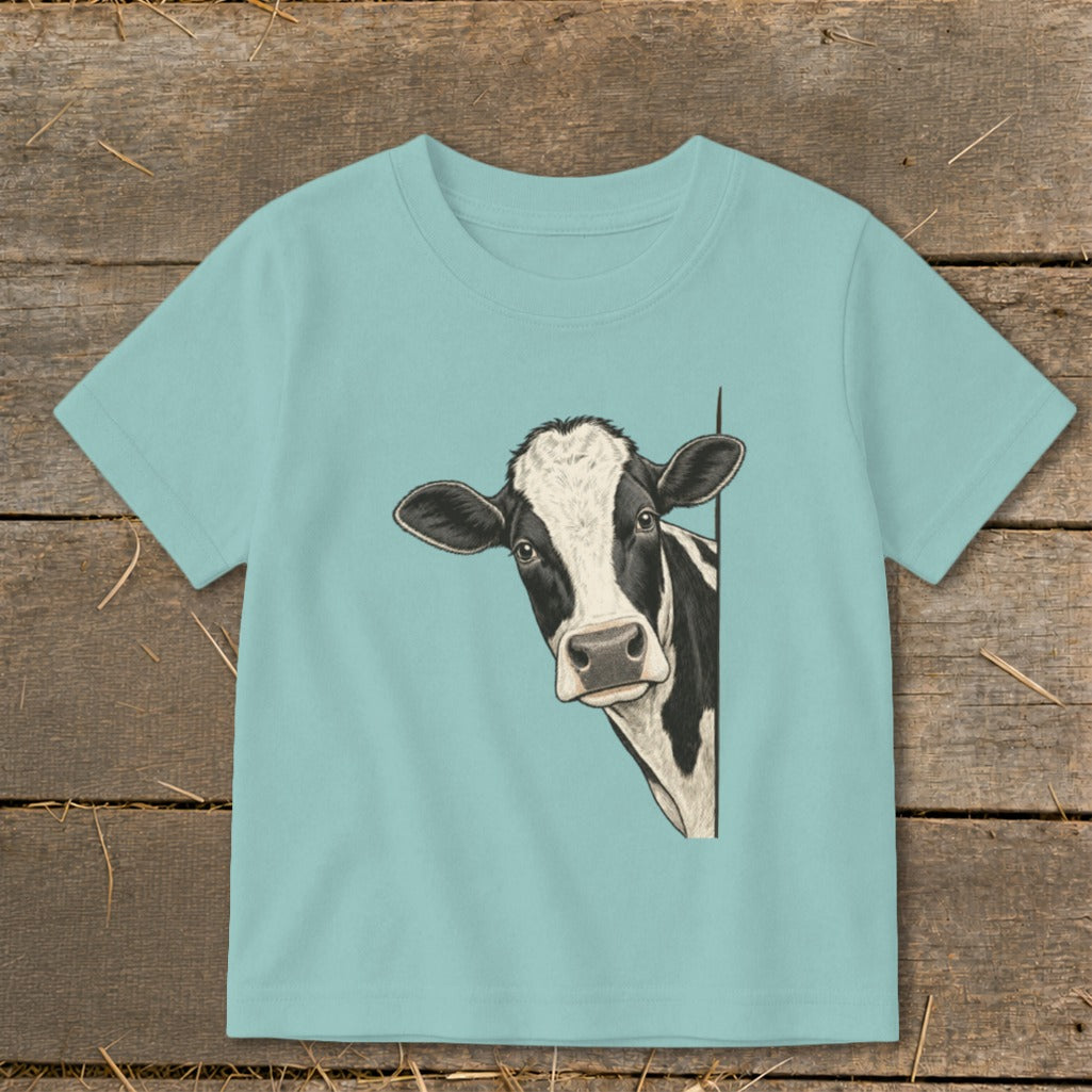 T-shirt with black and white cow peeking from the side.