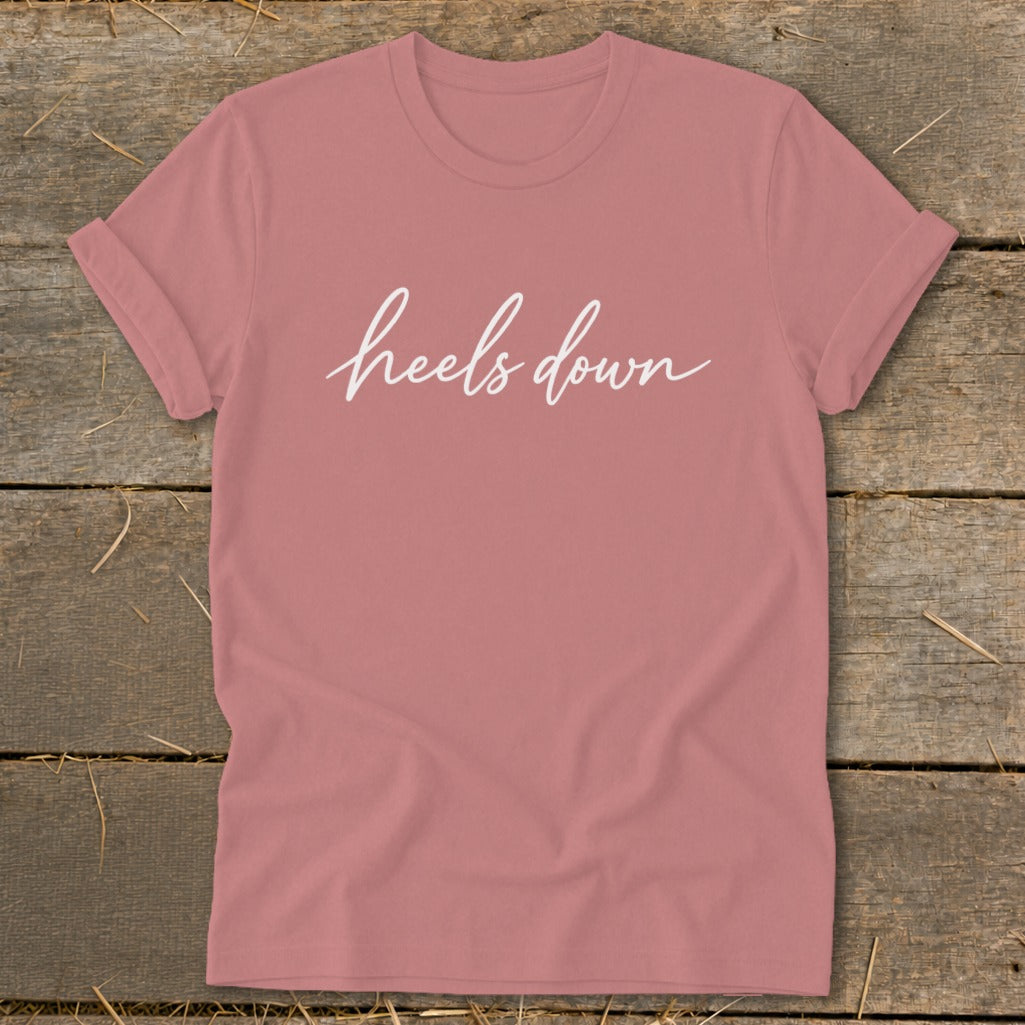 Rose t-shirt with white cursive text that reads "heels down".