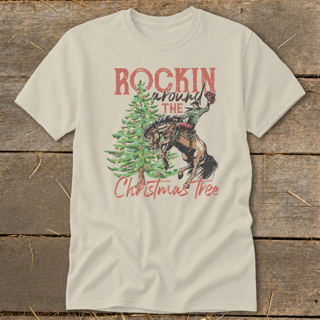 T-shirt graphic: "Rockin' Around The Christmas Tree" with cowboy on bucking horse.