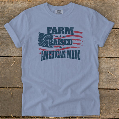Light blue t-shirt with distressed American flag and text "FARM RAISED AMERICAN MADE".