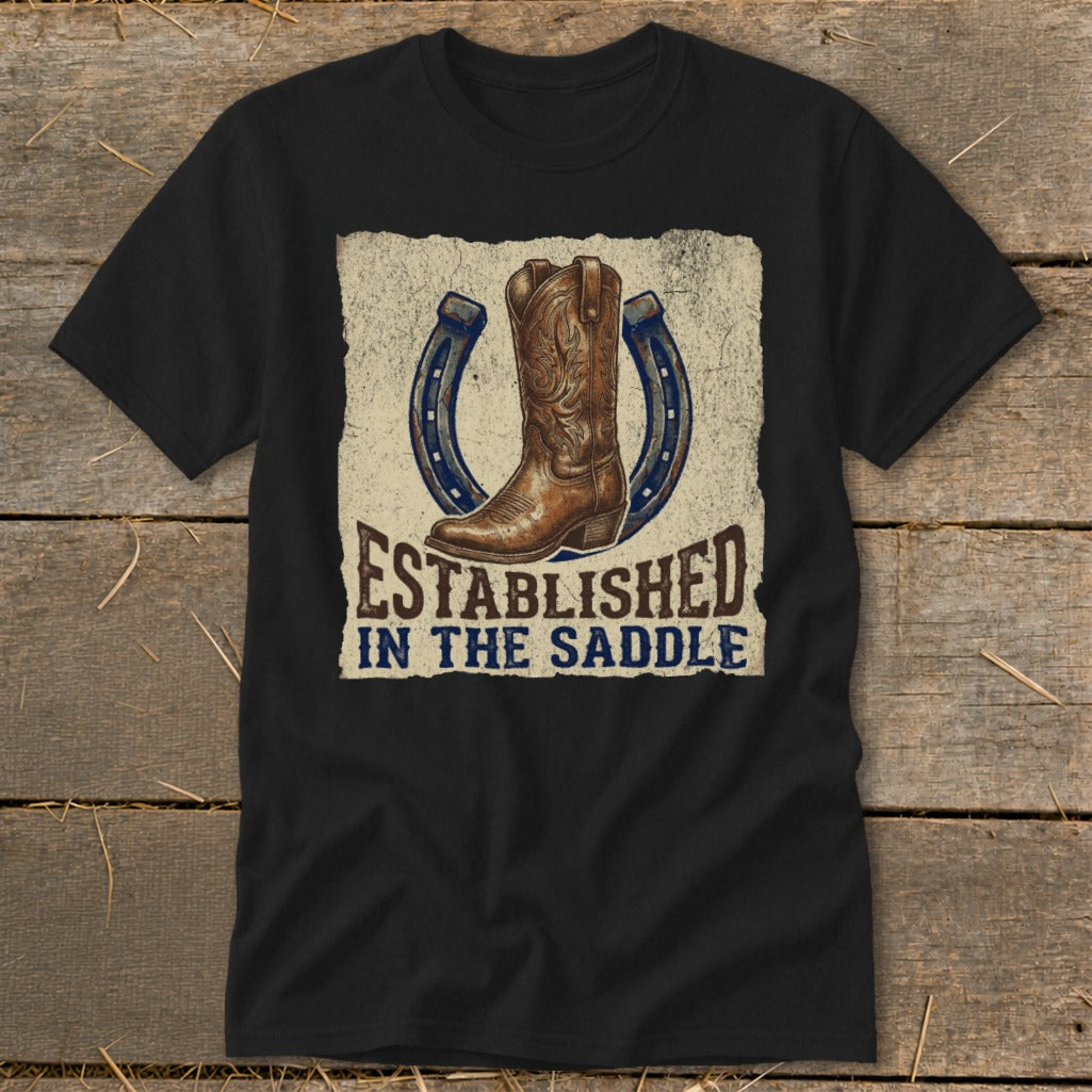 Black t-shirt with a cowboy boot and horseshoes graphic reading "Established In The Saddle".